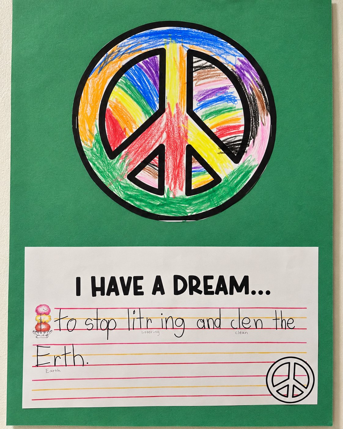 A child&rsquo;s drawing of a rainbow peace sign above the handwritten words I have a dream to stop littering and clean the earth