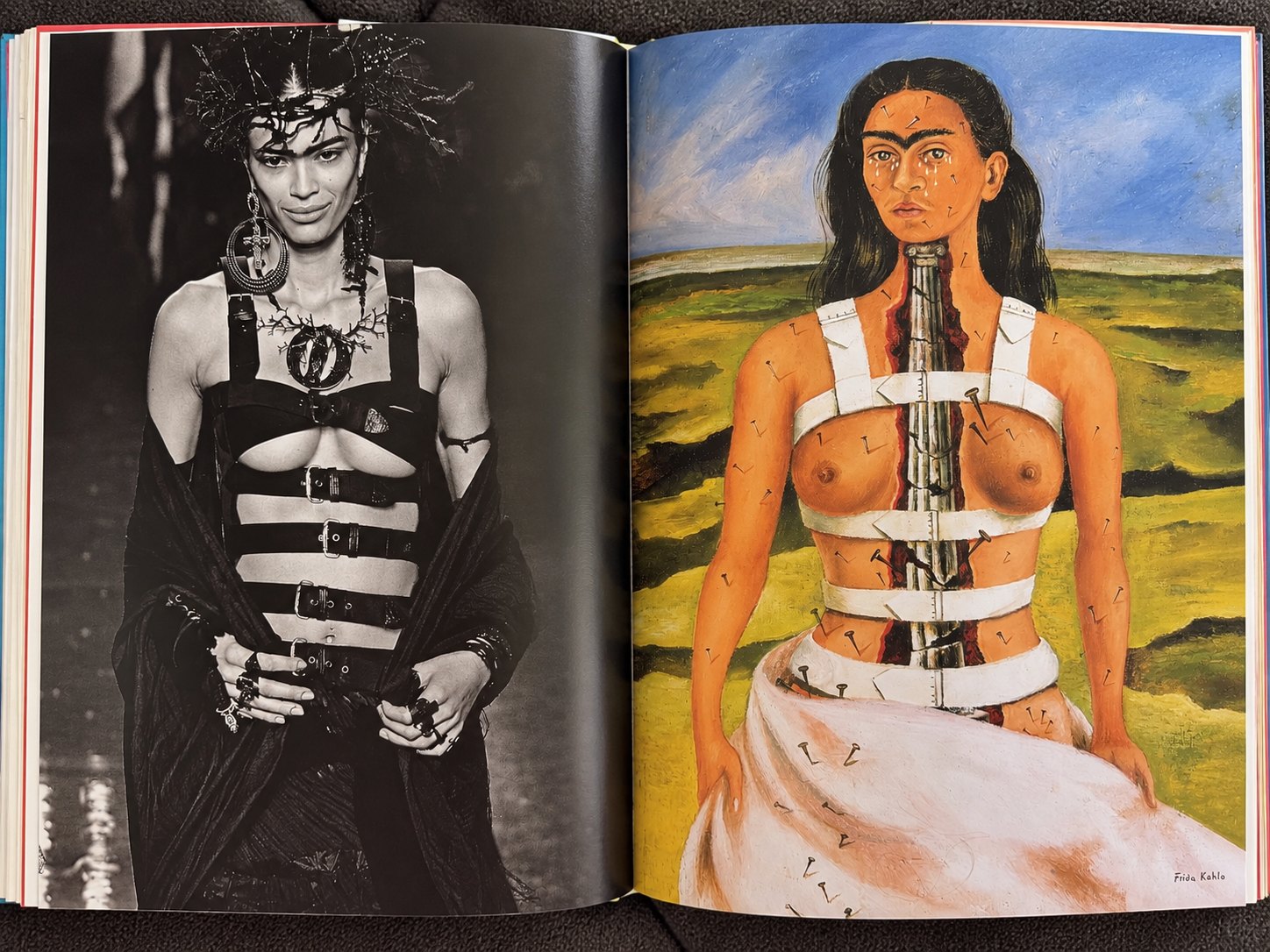 An open book spread: a black buckled corset look with a thorn headpiece on the left, The Broken Column reproduced on the right