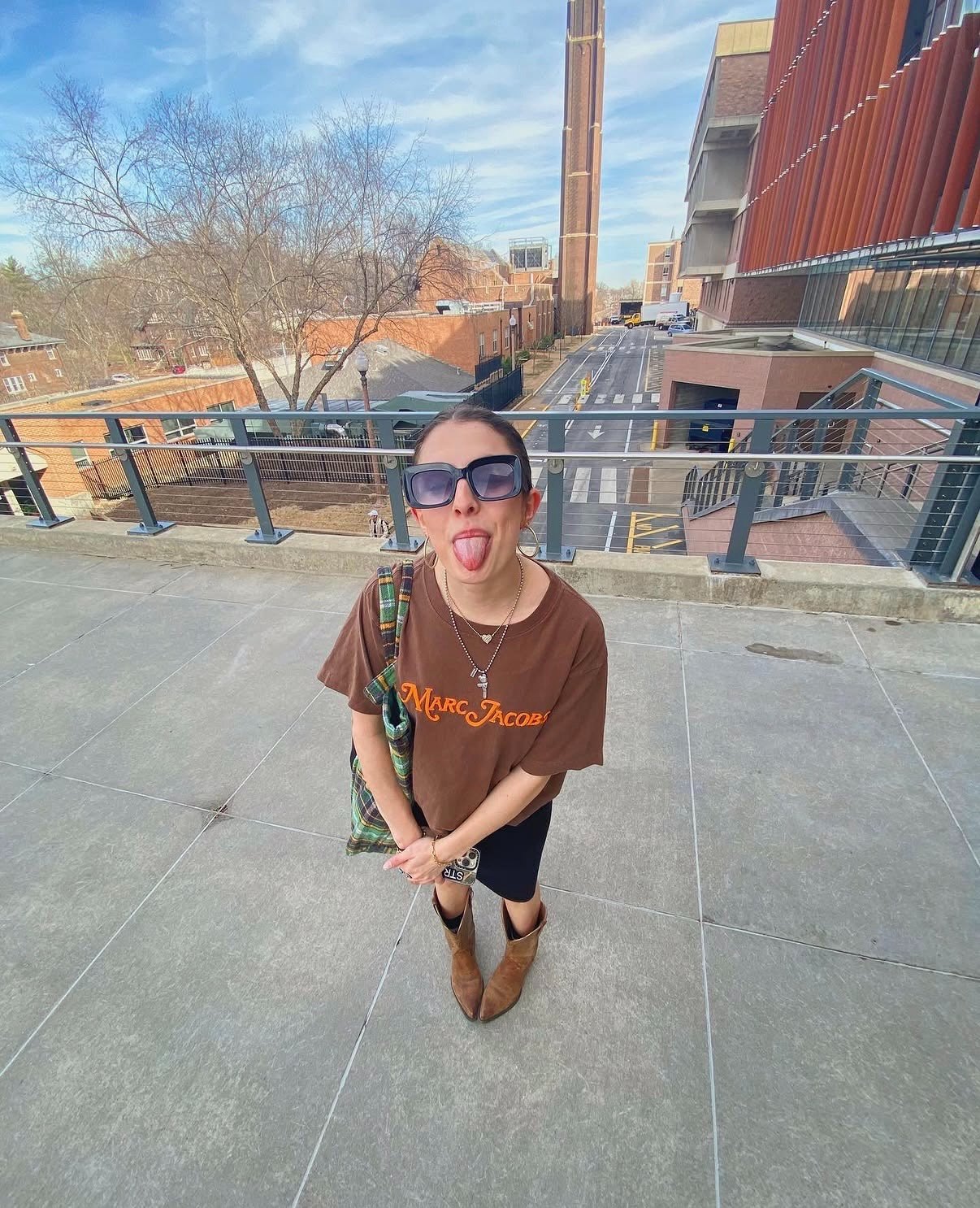 Aliya on a walkway in a brown Marc Jacobs T-shirt, shot from above