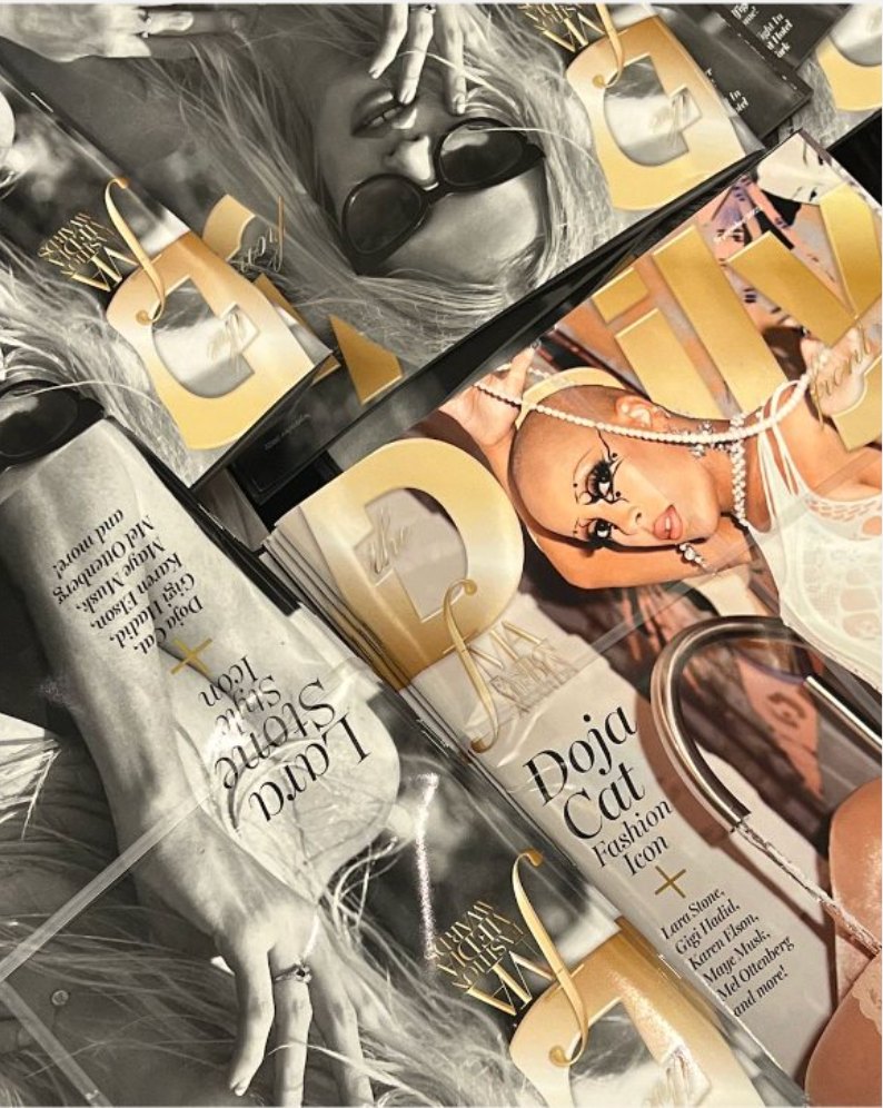 A pile of bagged Daily Front Row magazines and gold party favors