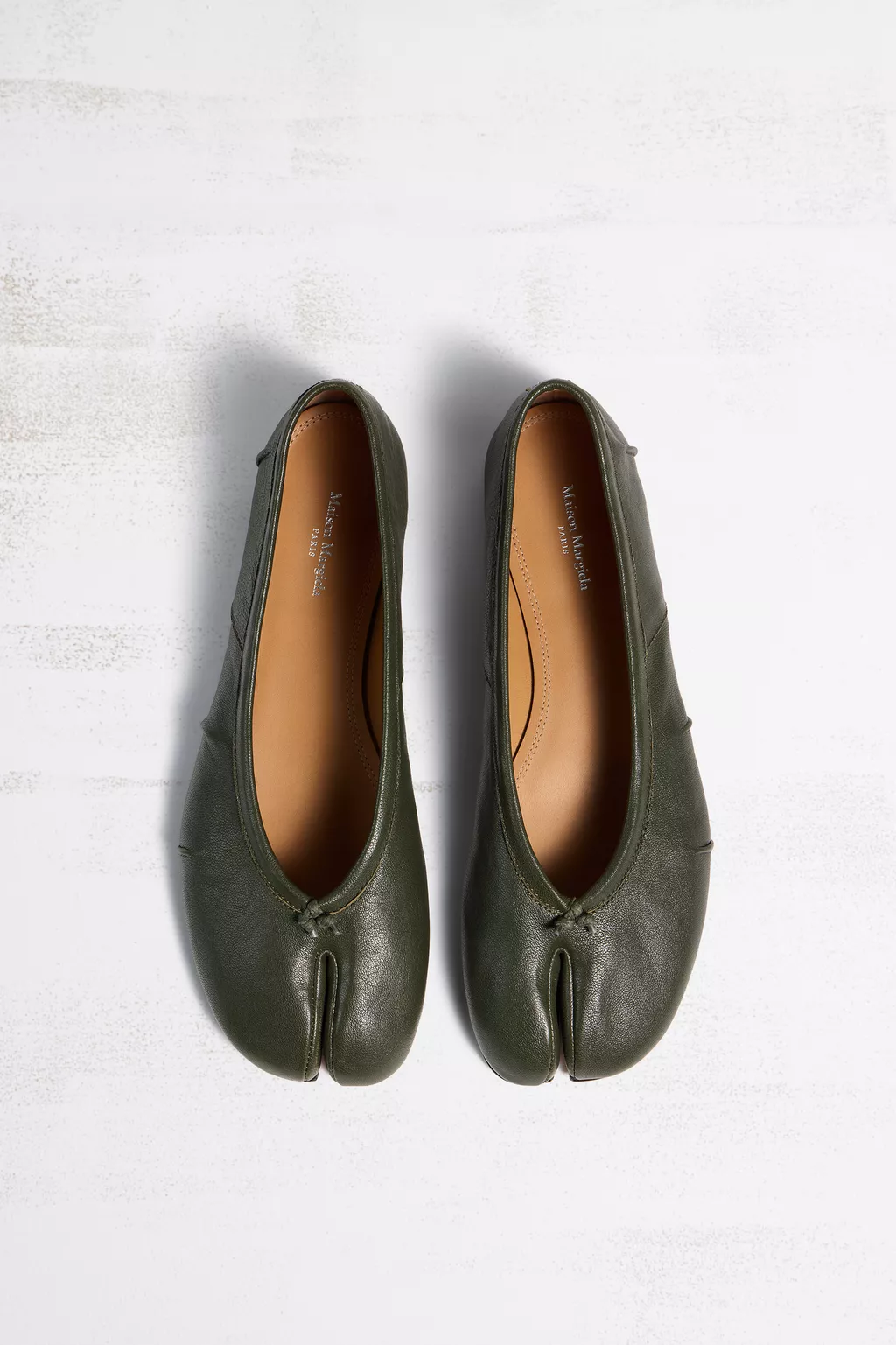 A pair of olive green Maison Margiela Tabi ballerina flats with their split toe, official product image